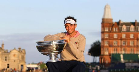 Dougherty poses with the trophy on the Swilken bridge