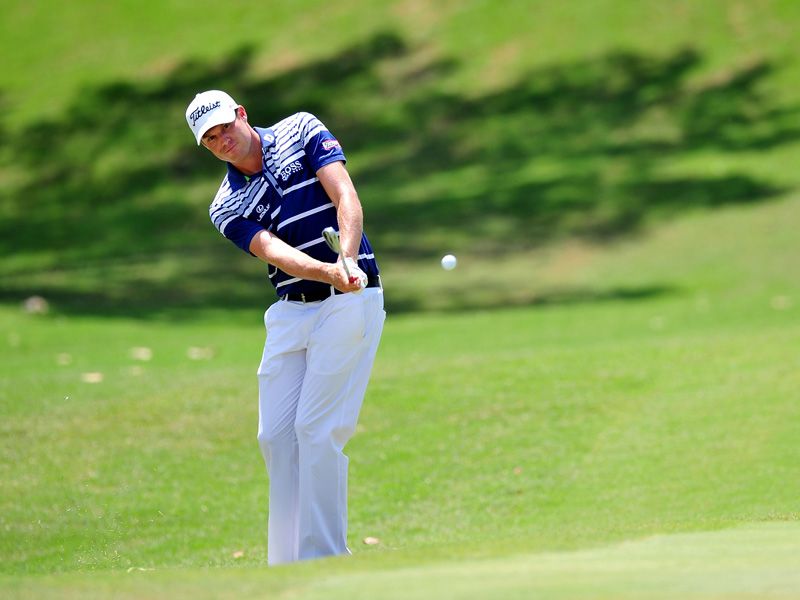 Nick Watney chips to the first green.