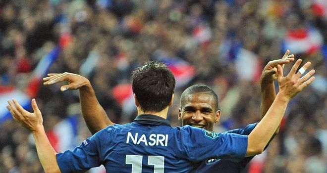 Samir Nasri puts club rivalry to one side as he celebrates with Florent Malouda in France's win