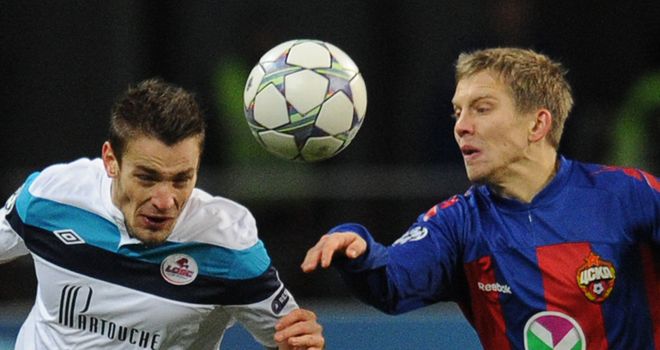 Mathieu Debuchy and Aleksandrs Cauna go for the same ball