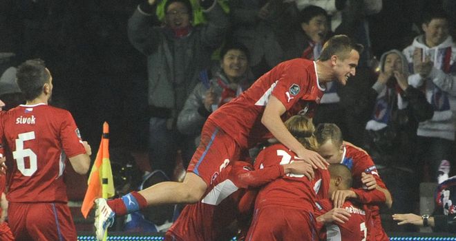 Vaclav Pilar: Czech ace is mobbed by his team-mates after opening the scoring