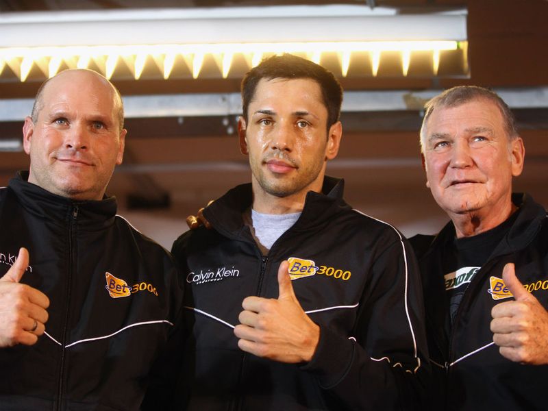 Me and my team: The reigning champion poses with his cornermen Clive Salz and Fritz Sdunek before he gets to work