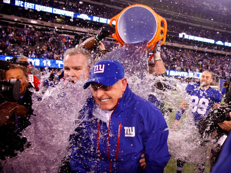 Giants coach Tom Coughlin is given a bath after his team beat Dallas to make the play-offs.