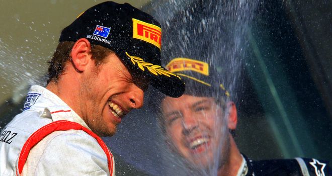 Sebastian Vettel (R) celebrates on the podium in Melbourne with race winner Jenson Button (L)