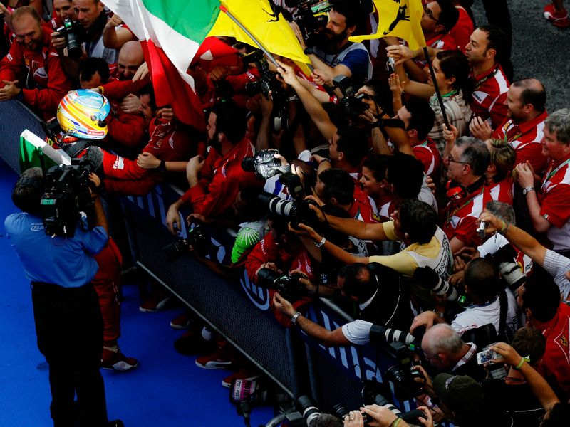 The Spaniard celebrates with the Ferrari team