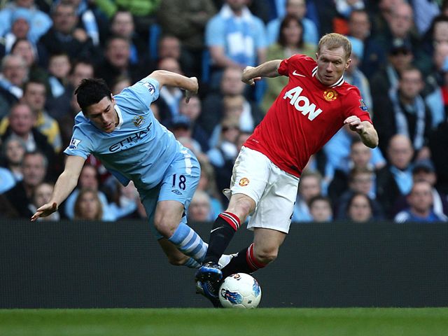 Gareth Barry and Paul Scholes tussle for possession