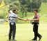Charl Schwartzel (L) shakes the hand of Louis Oosthuizen (R) after the first round of the Malaysian Open