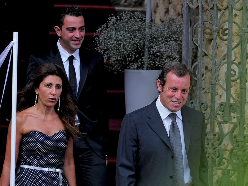 ...along with Barcelona President Sandro Rossel and Iniesta's partner in crime Xavi.