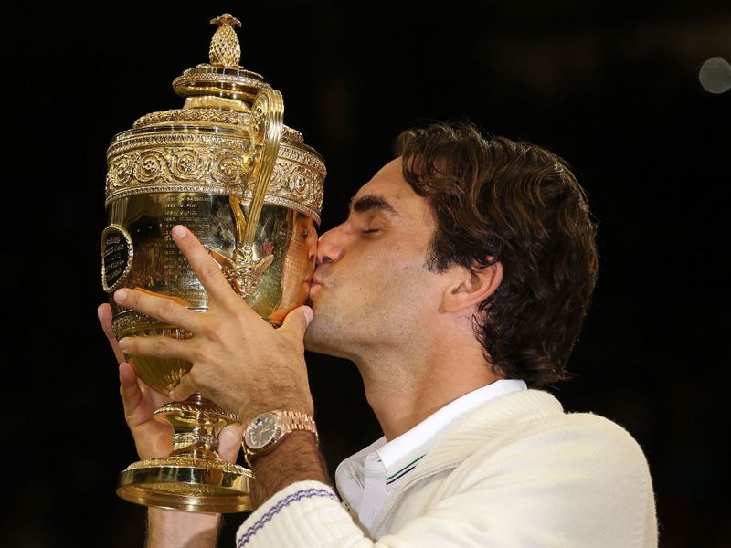 Roger Federer becomes a Wimbledon champion for a record seventh time, defeating a valiant Andy Murray in four sets in the men's singles final.
