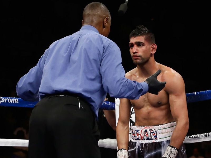 Khan is counted out by referee Kenny Bayliss