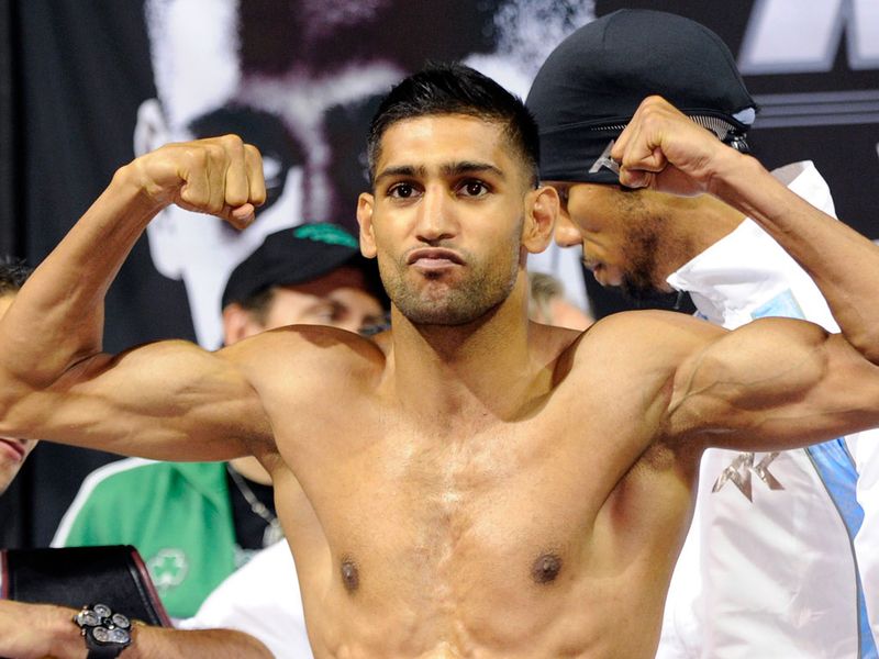 Khan looked lean as he weighed in one pound under the 140lb limit