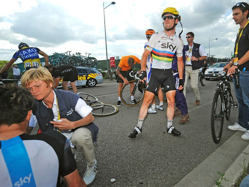 Cavendish gets to his feet as Eisel receives treatment - thankfully both seem to have avoided serious injury