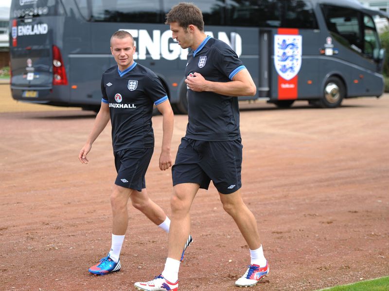 Manchester United team-mates Tom Cleverley and Carrick in conversation near the England team bus.