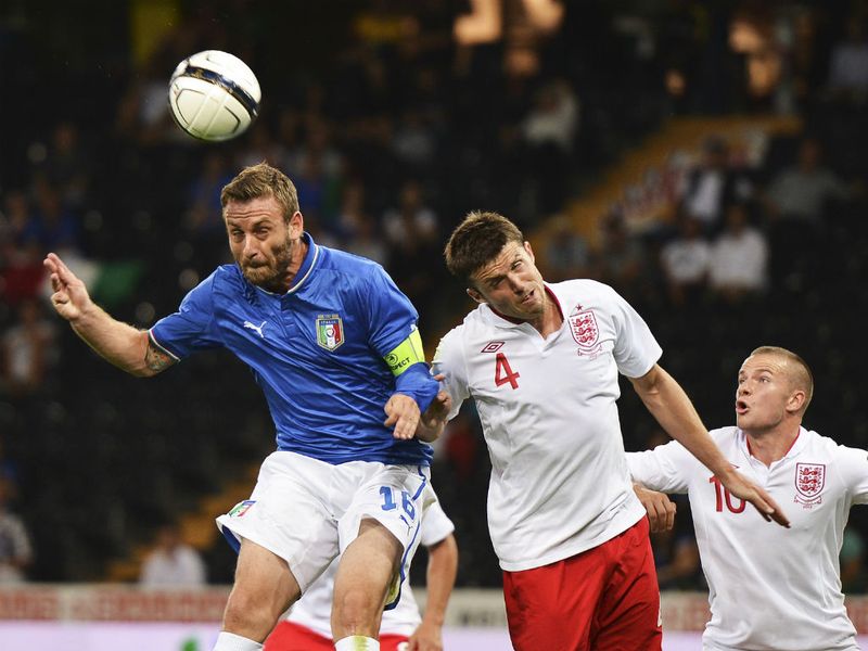 Daniele De Rossi gets above midfielder Michael Carrick to score the opening goal of the game in Berne.