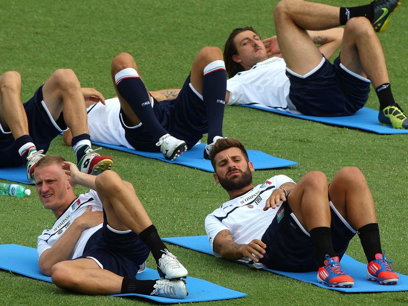 Meanwhile, at Coverciano near Florence, Italy's players are limbering up too. Ignazio Abate and Antonio Nocerino go through their stretches.