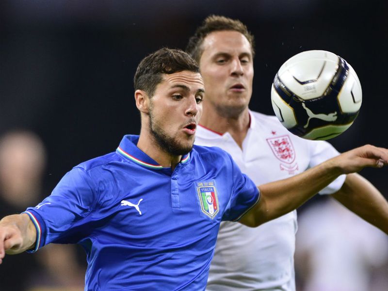 Italian forward Mattia Destro battles with English defender Phil Jagielka.