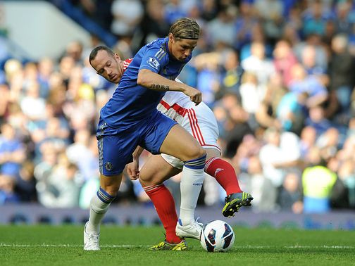 Fernando Torres tries to get clear of Charlie Adam