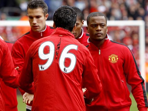 Luis Suarez and Patrice Evra shake hands