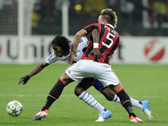 Philippe Mexes and Dieudonne Mbokani battle for the ball