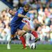 Fernando Torres tries to get clear of Charlie Adam