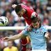 Laurent Koscielny and Edin Dzeko in aerial battle