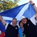 Paul Lawrie hoists the flag of Scotland and celebrates victory with his wife and caddie.