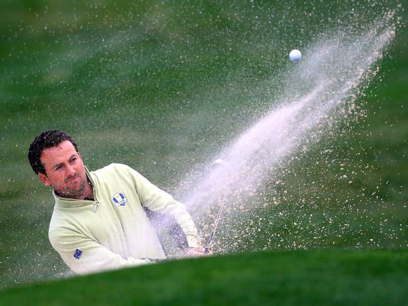 Graeme McDowell rescues a shot out of the bunker on the eighth hole.