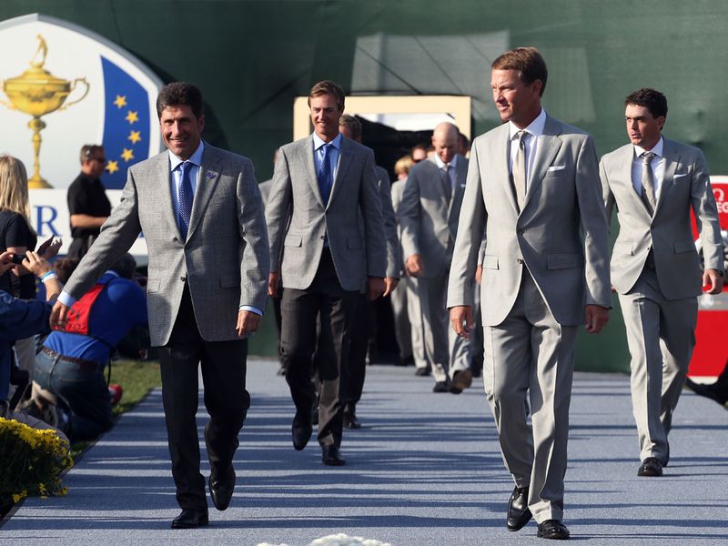 Captains Jose Maria Olazabal and Davis Love lead their teams out at the opening ceremony