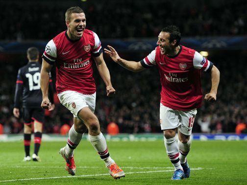 Lukas Podolski and Santi Cazorla celebrate for Arsenal