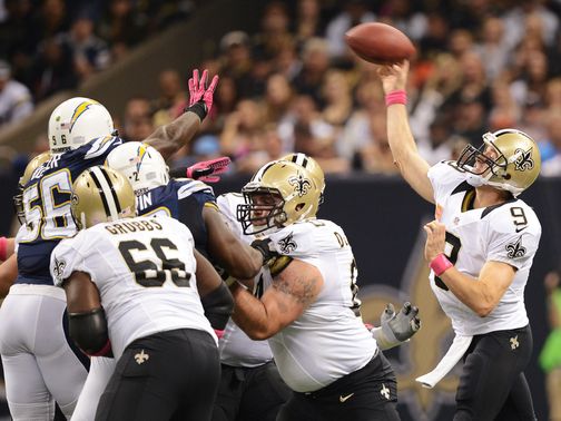 Brees gets a pass away over the linemen