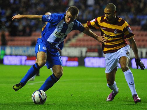 Callum McManaman and James Meredith battle for the ball