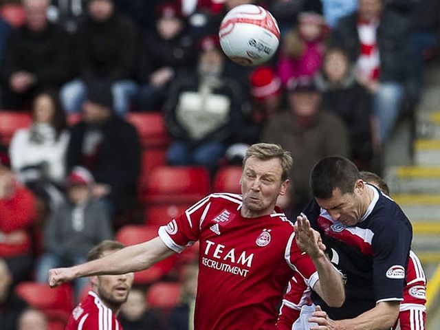 Nish beats Hughes to a header.