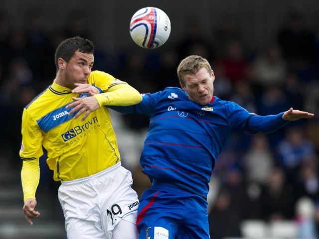Miller and McKay go up for a header.