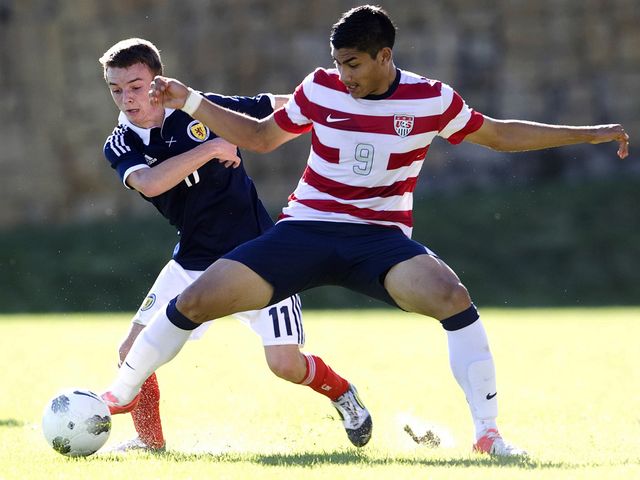Stefan Scougall is held off by Mario Rodriguez