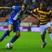 Latics frontman Callum McManaman tries to keep Bradford's James Meredith at bay.