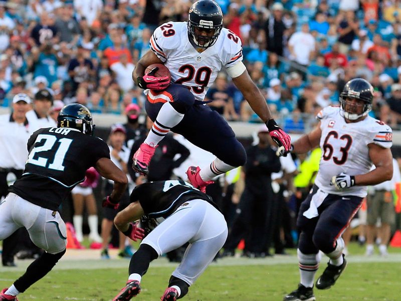 Michael Bush takes the high road to evade a Jacksonville defender