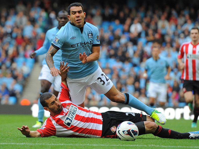 Just four minutes into Saturday's opening fixture, Carlos Cuellar brings Tevez down on the edge of the area.