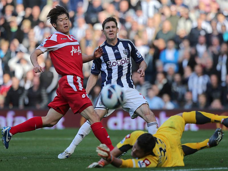 Queens Park Rangers keeper Julio Cesar makes a save from Zoltan Gera as WBA look to extend their lead further.