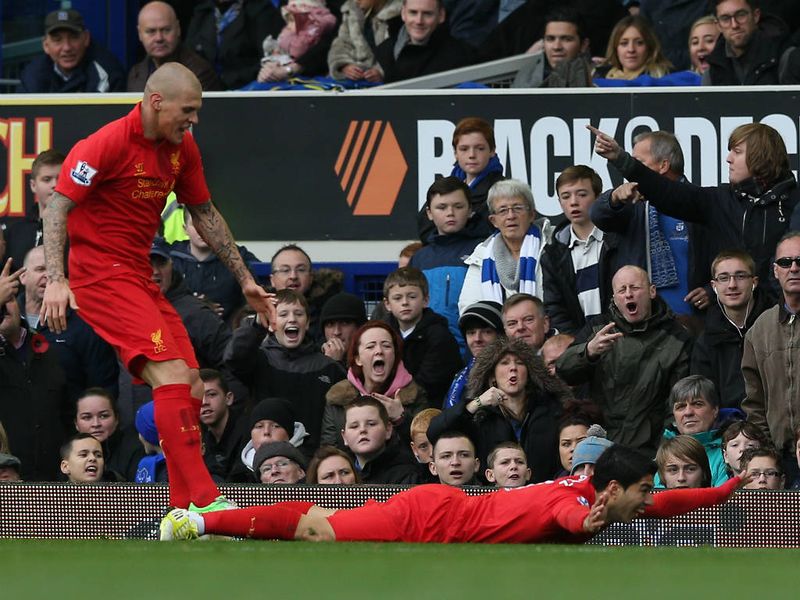 Suarez celebrated the opening goal by diving in front of David Moyes following pre-match comments by the Everton manager