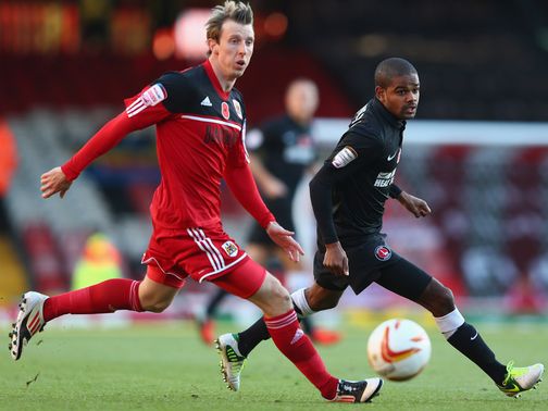 Martyn Woolford and Bradley Pritchard vie for the ball