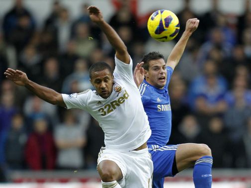 Wayne Routledge and Cesar Azpilicueta battle for the ball