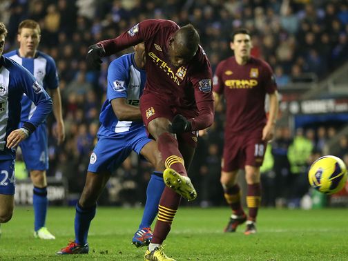 Mario Balotelli scores against Wigan to the delight of Cheeky