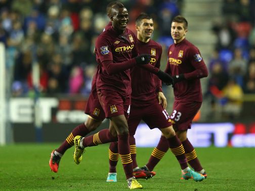 Mario Balotelli celebrates his goal at Wigan