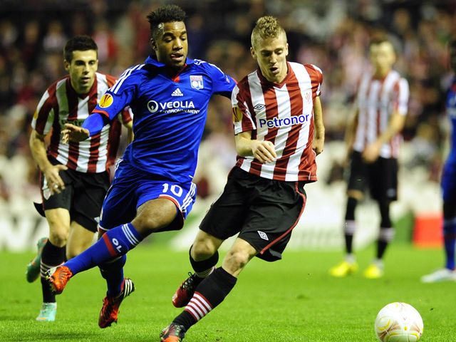 Alexandre Lacazette and Iker Muniain battle for the ball
