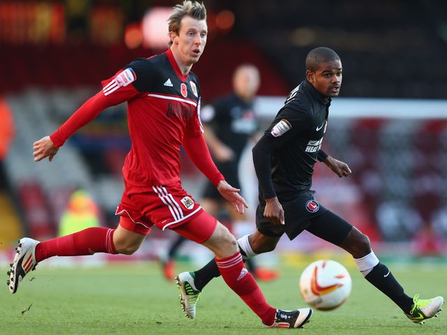 Martyn Woolford and Bradley Pritchard vie for the ball