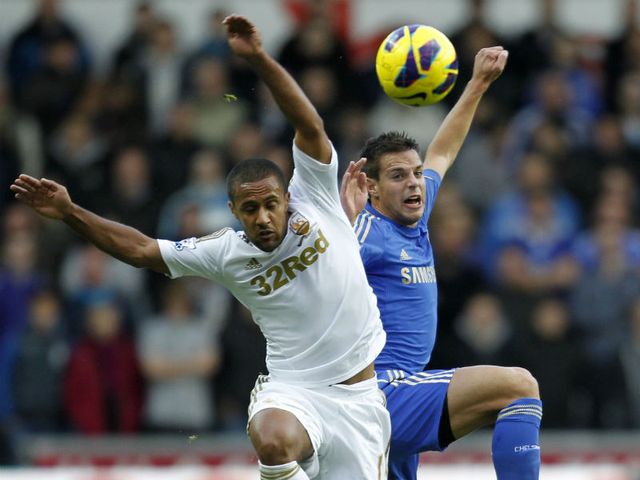 Wayne Routledge and Cesar Azpilicueta battle for the ball