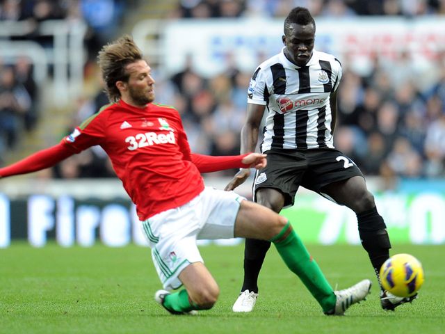 Miguel Michu slides in to tackle Cheick Tiote