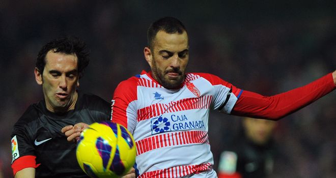 Diego Godin battles for the ball