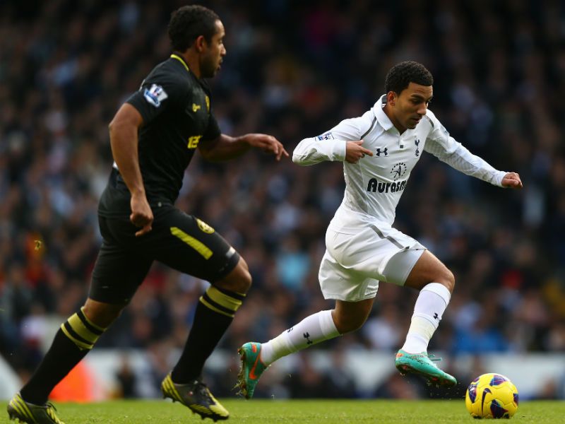 Battling hard: Aaron Lennon of Tottenham Hotspur is put under pressure by Wigan's Jean Beausejour...