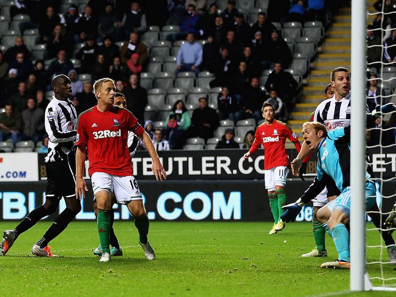 Demba Ba scores a consolation goal for Newcastle United against Swansea City.